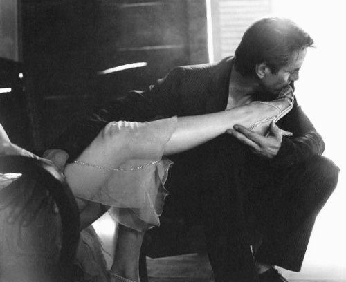 A man kissing a woman’s feet. Just pure devotion.