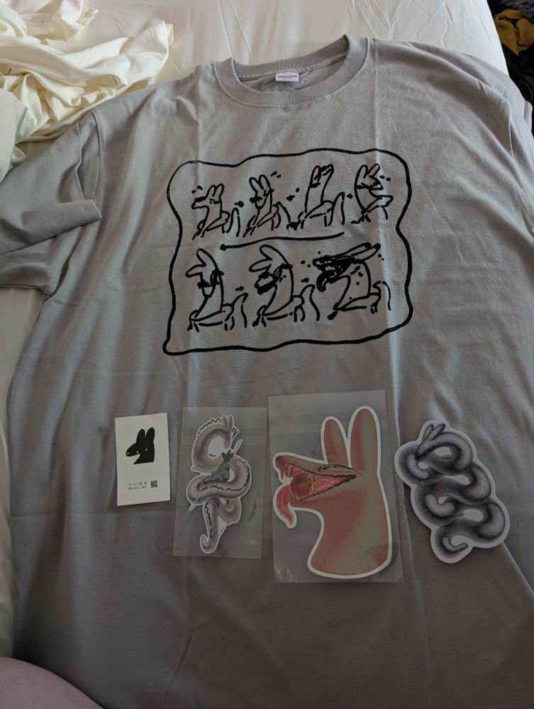 A tee-shirt with a woodblock print of a creature with long ears and a snout progressively blushing
