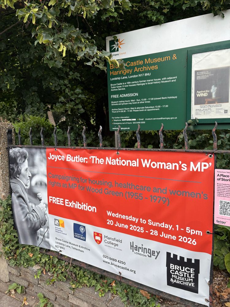 Sign hung on a railing advertising ‘Joyce Butler: The National Women’s MP’ exhibition 