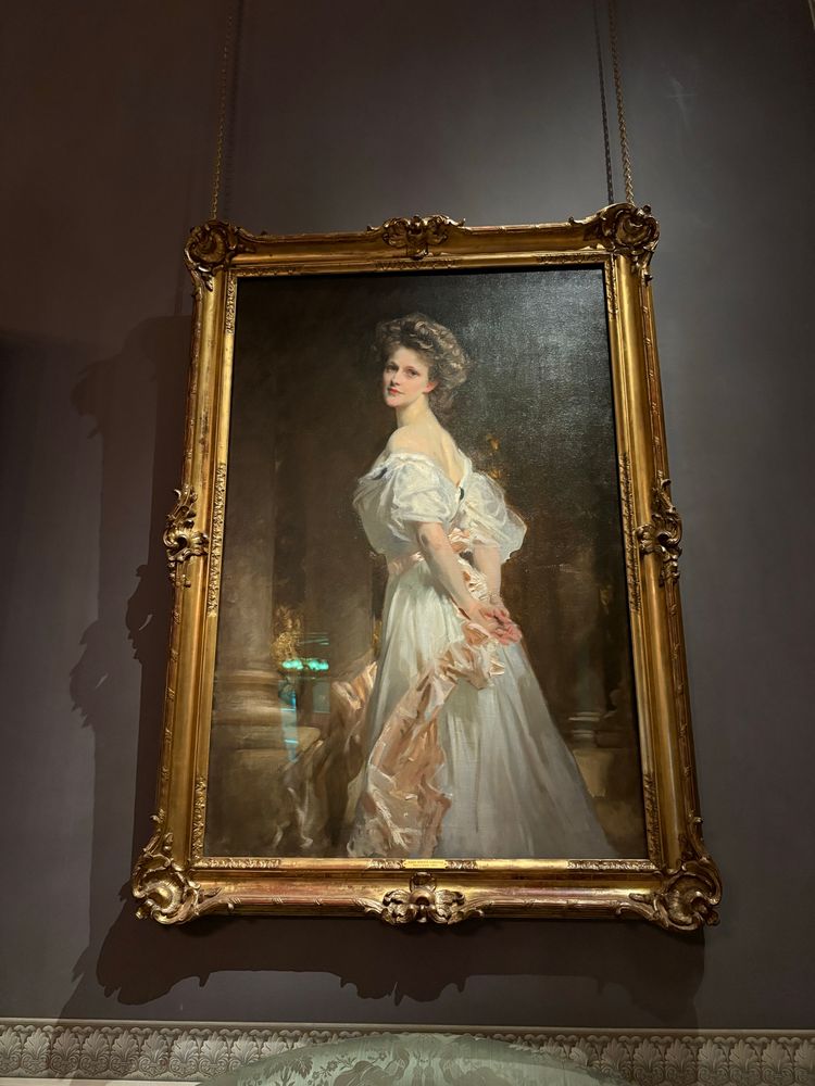 Large society portrait of a young Nancy Astor with big hair  in a white dress