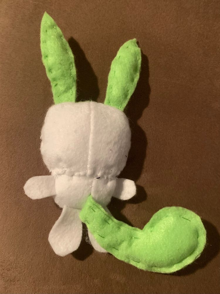 Photo of same plush but turned around backside. 

Backside of head should be green like its ears but I forgot, so it’s white instead.