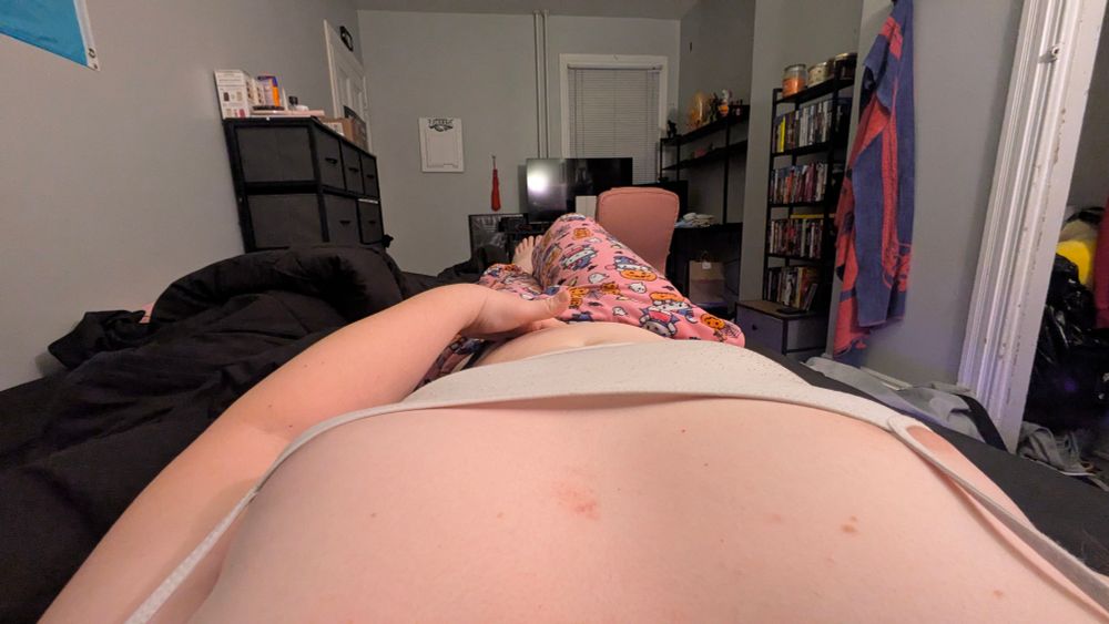 a pov shot of me in my bed doing the pose from the quoted post. the pov is as if you were me. you can see my bedroom around me, including a tv and desk, shelving for physical media, figures on my desk shelf, and a dresser.