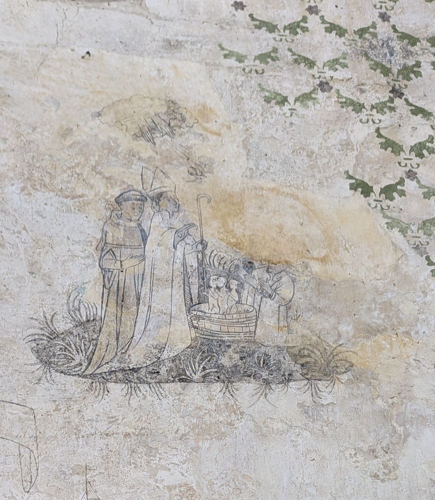 A medieval wall illustration of a man with a hooked crook and a mitre, next to a man with a monk-style haircut. There are three children in a basin.
