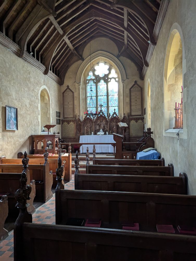 A very small Victorian church, only about 5 rows of pews visible, plus the altar and main window