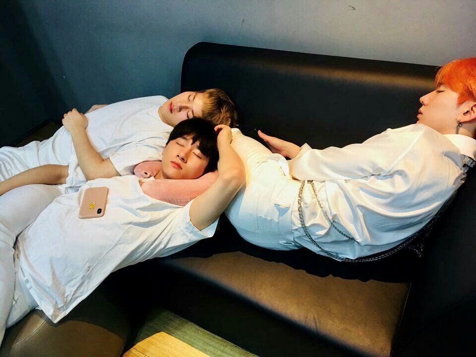 kihyun sleeping on the couch and jooheon and changkyun sleeping next to his legs