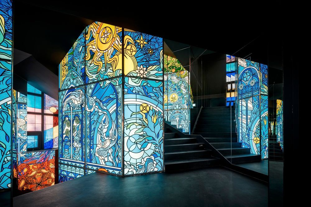 A stairway enveloped by luminous stained glass.