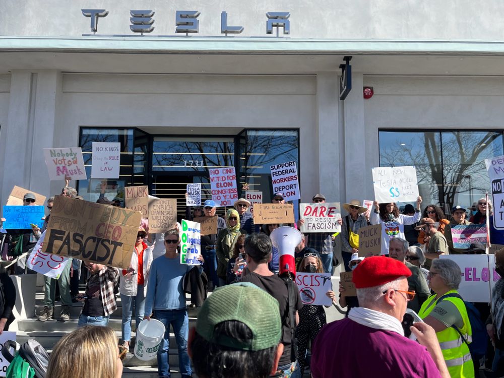 Protesters outside the Tesla dealership in Berkeley, CA.