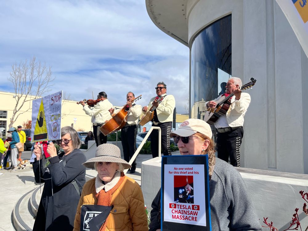 Mariachi band and protesters in front of the Berkeley, CA Tesla dealership.