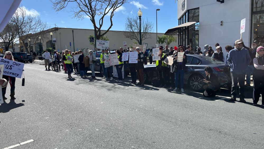 Protesters in front of the Berkeley, CA Tesla dealership.