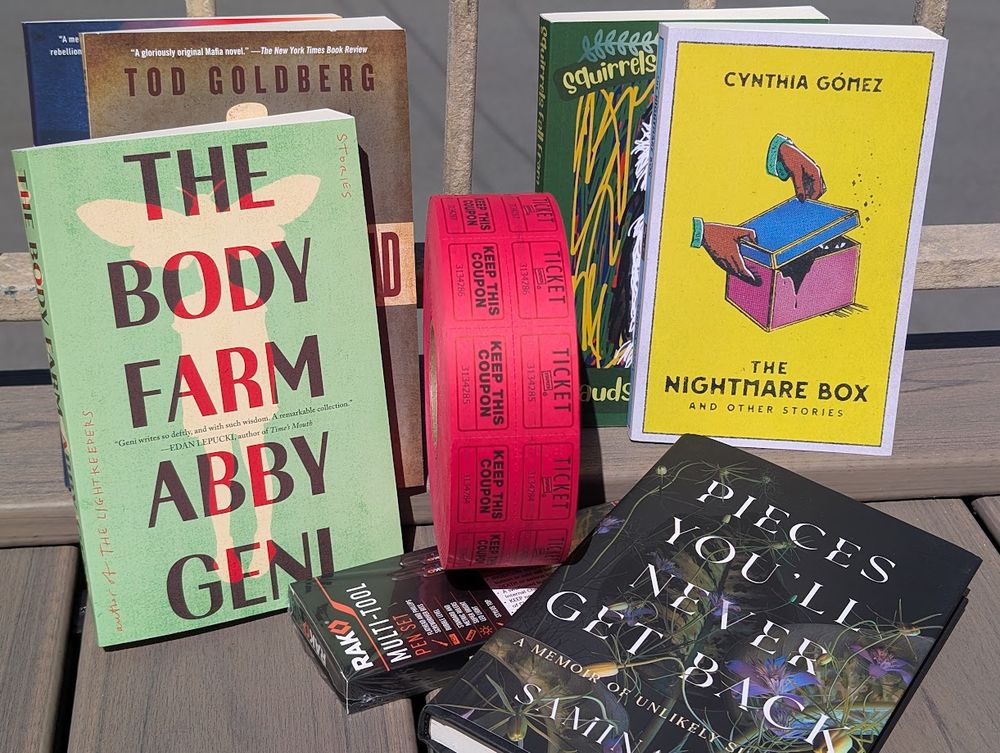 A group of books arranged around raffle tickets
