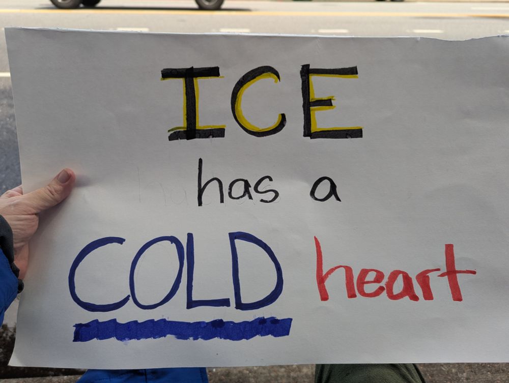 White sign that say ICE has a cold heart. 