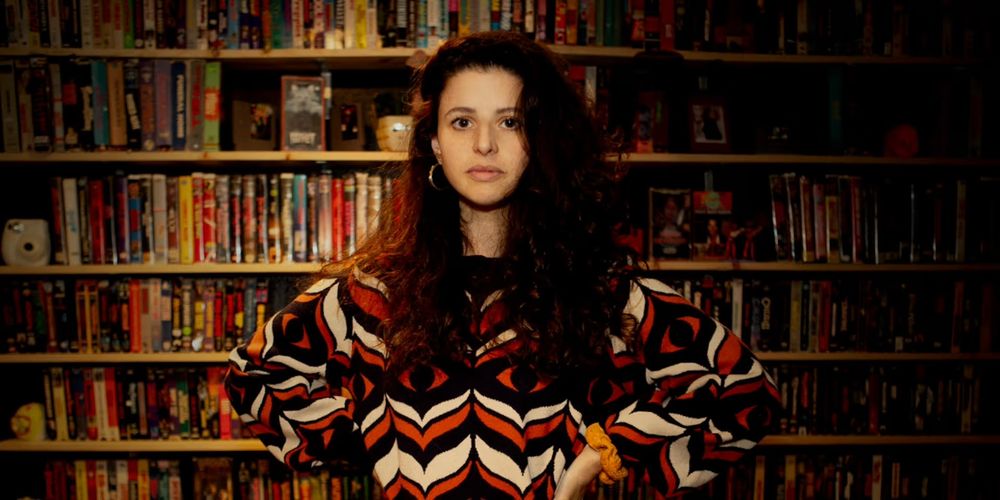 Director of Very Important People Tamar Levine posing in front of bookshelf 