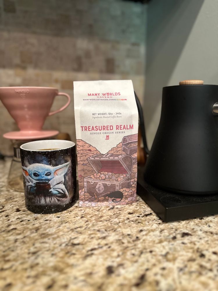 In this picture there is a coffee mug, a v60 coffee dripper, and the hopes and dreams of morning productivity.