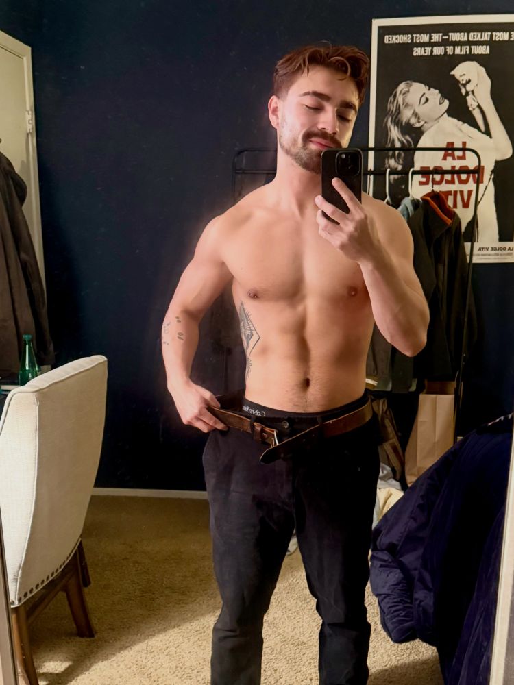 Shirtless muscular man taking a selfie and pulling out a very loose waistband