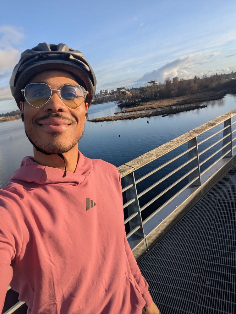 a selfie of me wearing my bicycle helmet, pink adidas training hoodie, and heart-rimmed sunglasses