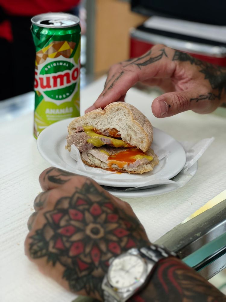 A traditional bifana, along with a can of Sumol. A snack.
