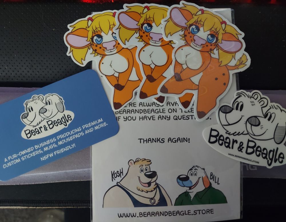 A selection of three stickers of Sophie the Cow and promotional material from Bear & Beagle print services