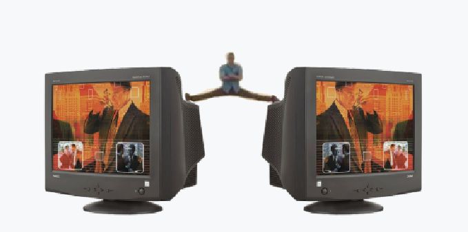 A badly photoshoped Jean-Claude Van Damme doing his famous splits on two giant old school CRT computer monitors