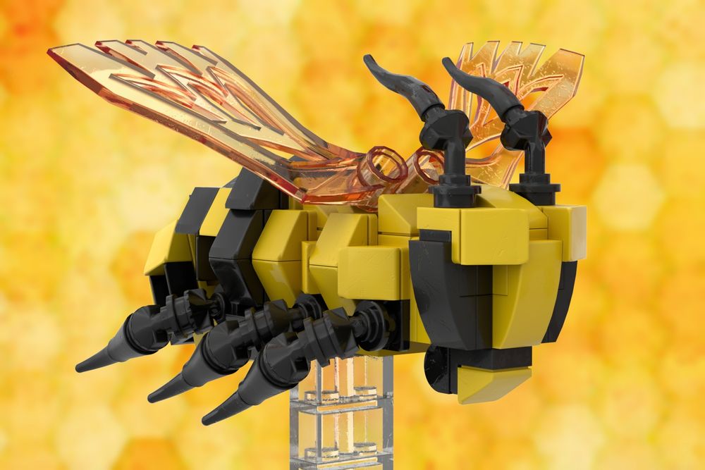 A bee made of LEGO modelling pieces, having a yellow body with black stripe, black, articulated legs, black antennae and mouth parts and amber wings.  It is supported by a clear plastic LEGO plinth;
