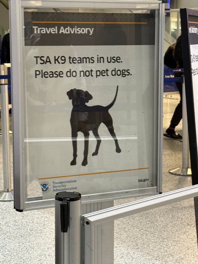 Sign in airport asking you not to pet service dogs