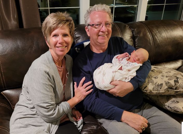 MP Mel Arnold of BC in a family picture holding a newborn.