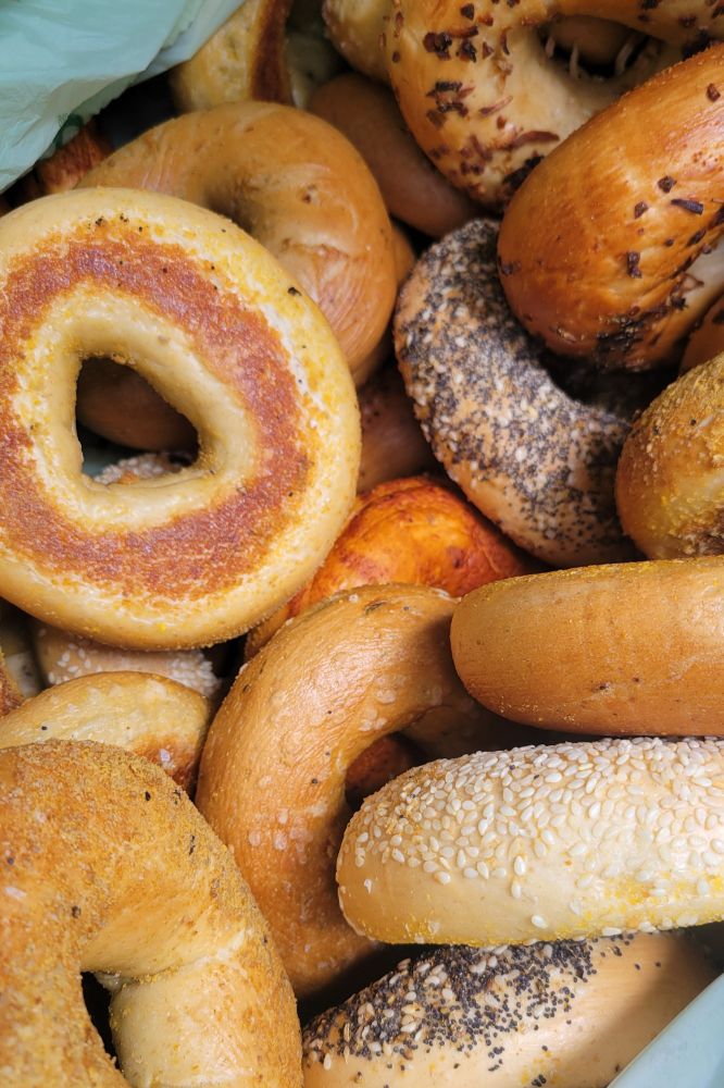 Various bagel flavors piled up in a bag