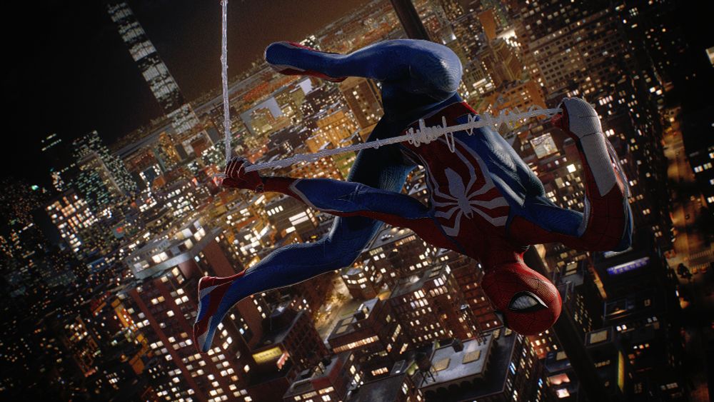 Spider-Man swinging updside down with the view of New York City on the background during the night