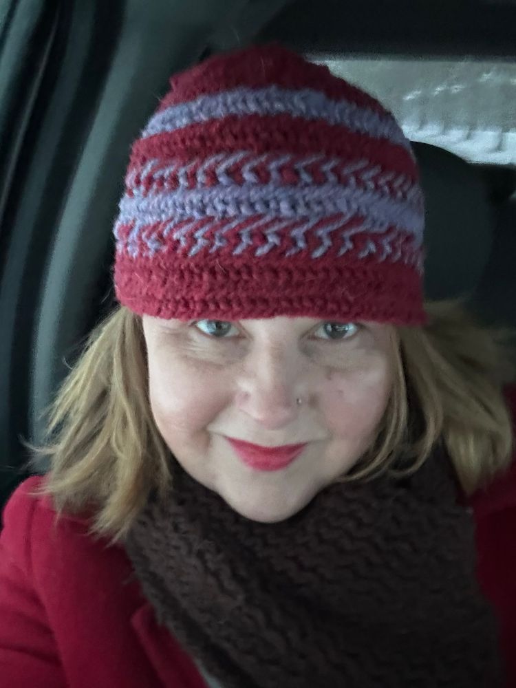 Its cold so I made a hat using nalbinding, an old technique of weaving with a needle. The hat is red and purple wool. Its my first time creating patterns with two colours.
