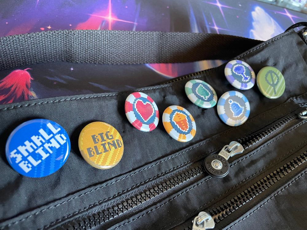An image of the several blinds from the game Balatro in the form of pinback buttons! They’re available for purchase at https://sketchwave.bigcartel.com