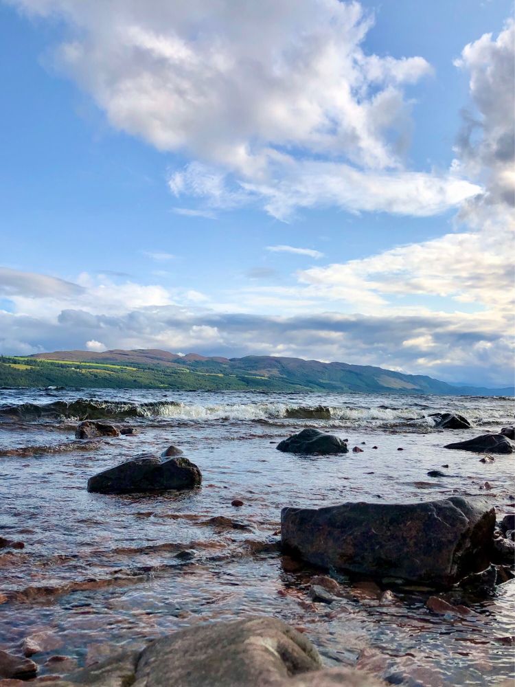 View of Loch Ness in late afternoon, taken from a rocky beach