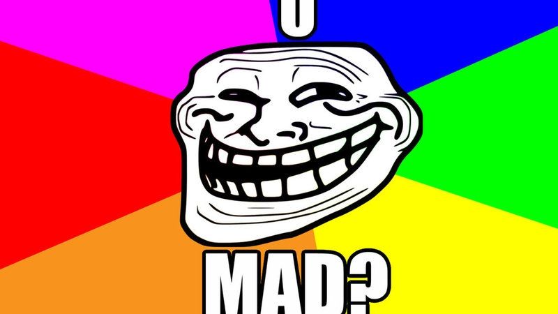The troll face on a rainbow background with text reading "u mad?".