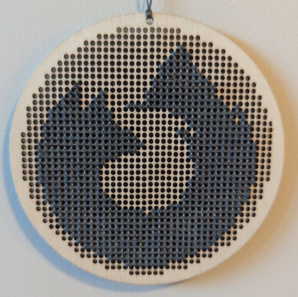 One-colour Firefox cross stitch on a wooden canvas.