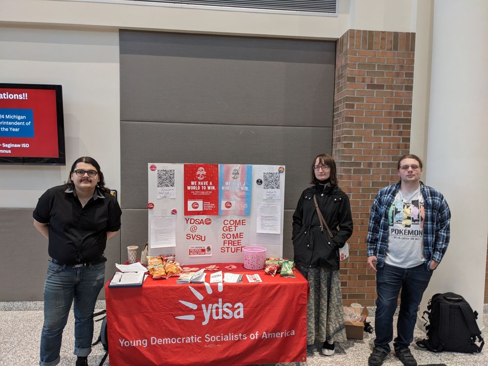 3 people at a YDSA tabling booth