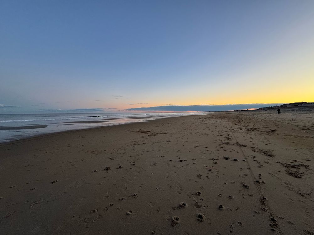 Sunset at the beach. Low clouds in the distance. 