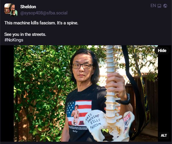 A post on infosec exchage of a man holding up a skeleton spine on which it says "This machine kills fascism." The post itself says. This machine kills fascism. It's a spine.