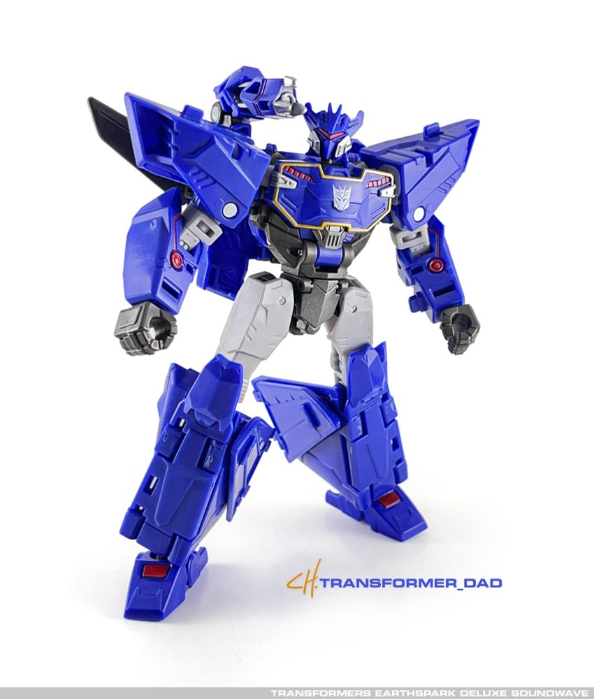 Transformers Earthspark Deluxe Soundwave. A mostly blue “pointy” robot on a white Backdrop.
