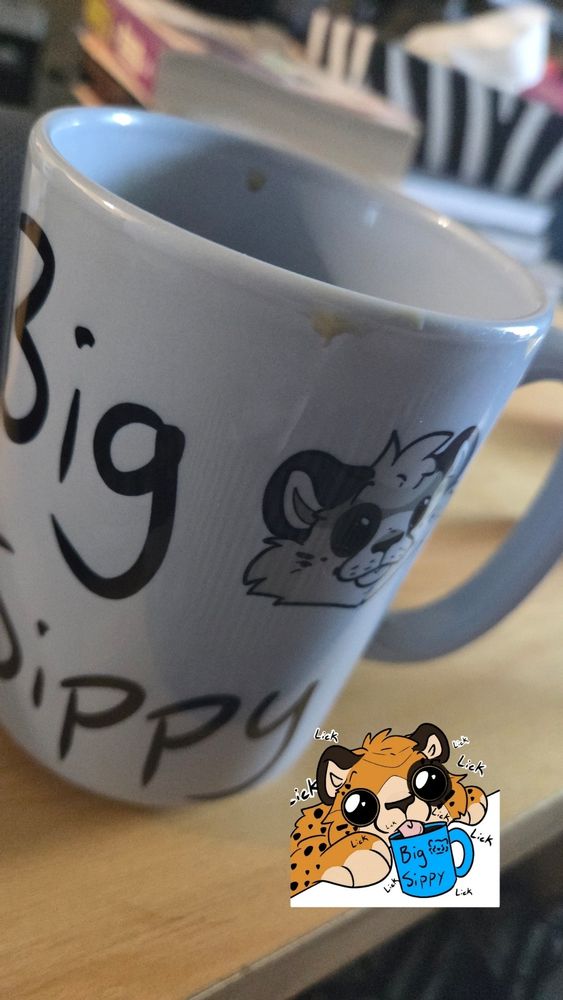 The cartoon sticker of me licking up coffee I don't mug that says big city, and has a cartoon sticker of me. On the table in the photo there is a real life version of the mug that says "big sippy" with a cartoon face of my chee. 