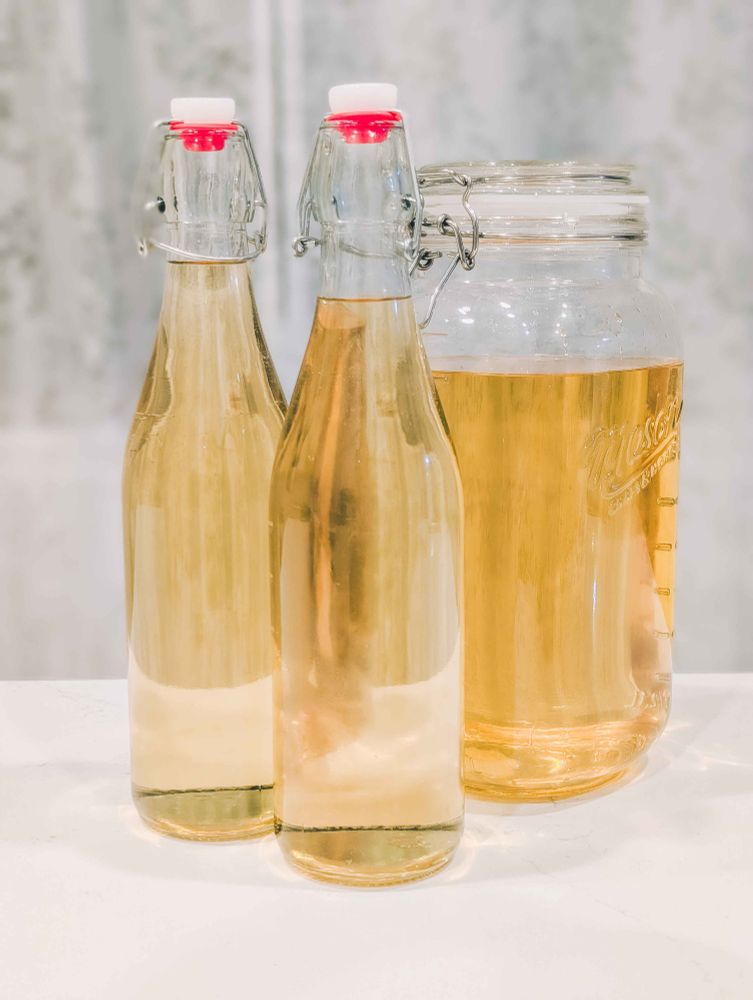 glass bottles and a glass mason jar filled with limoncello