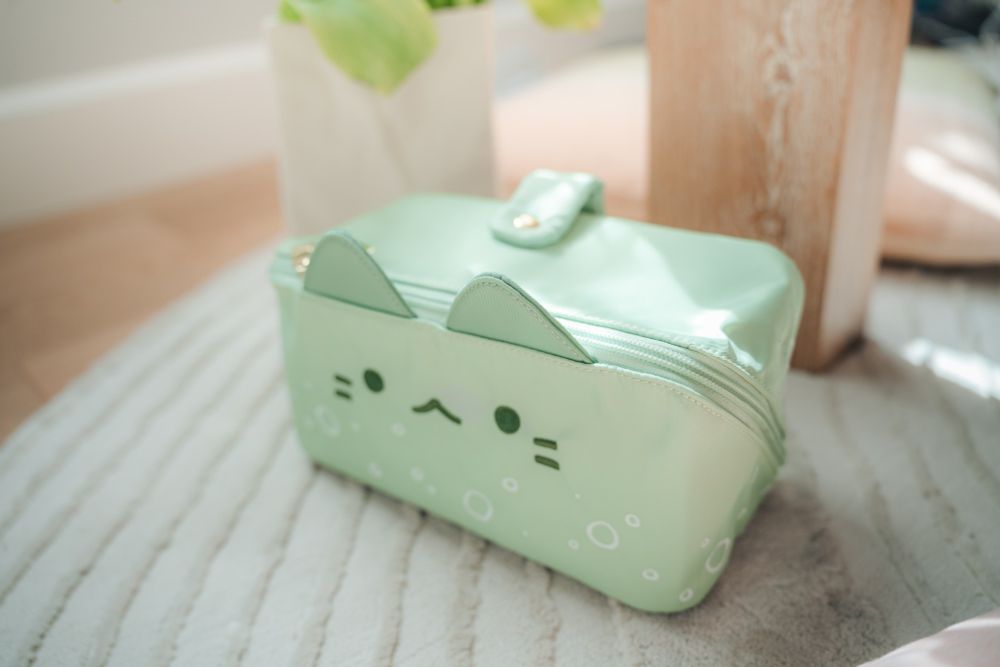 a light green cat-shaped makeup bag
