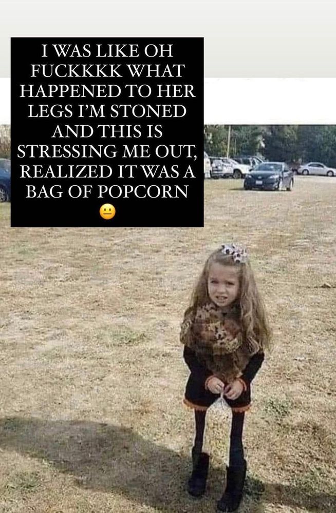 This poor little girl, standing in an open field with the saddest skinny legs anyone has ever seen, they are like toothpicks and she needs he-- oh shit, she's holding a bag of popcorn in front of her. Caption 