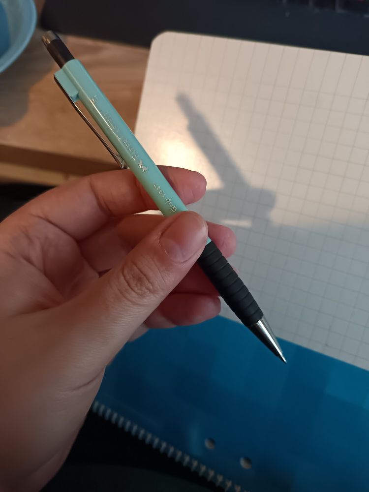 A hand holding the most awesome mechanical pencil it ever has! 