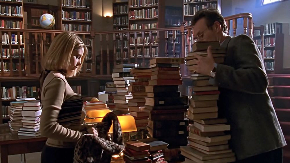 giles with books (buffy the vampire slayer)