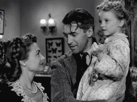 a black and white photo of a man and woman holding a little girl .