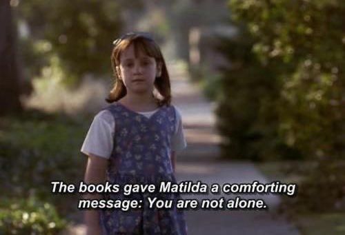 Matilda walking with her wagon of books. Text says: The books gave Matilda a comforting message: You are not alone. 