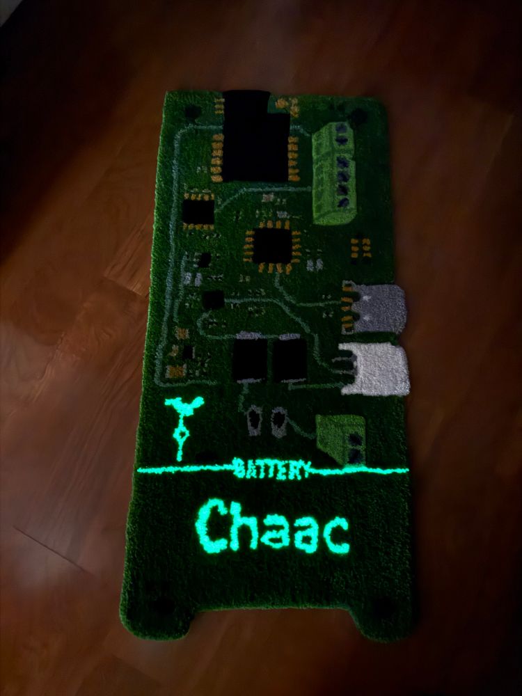 A picture of the rug that looks like a circuit board with glow-in-the-dark components