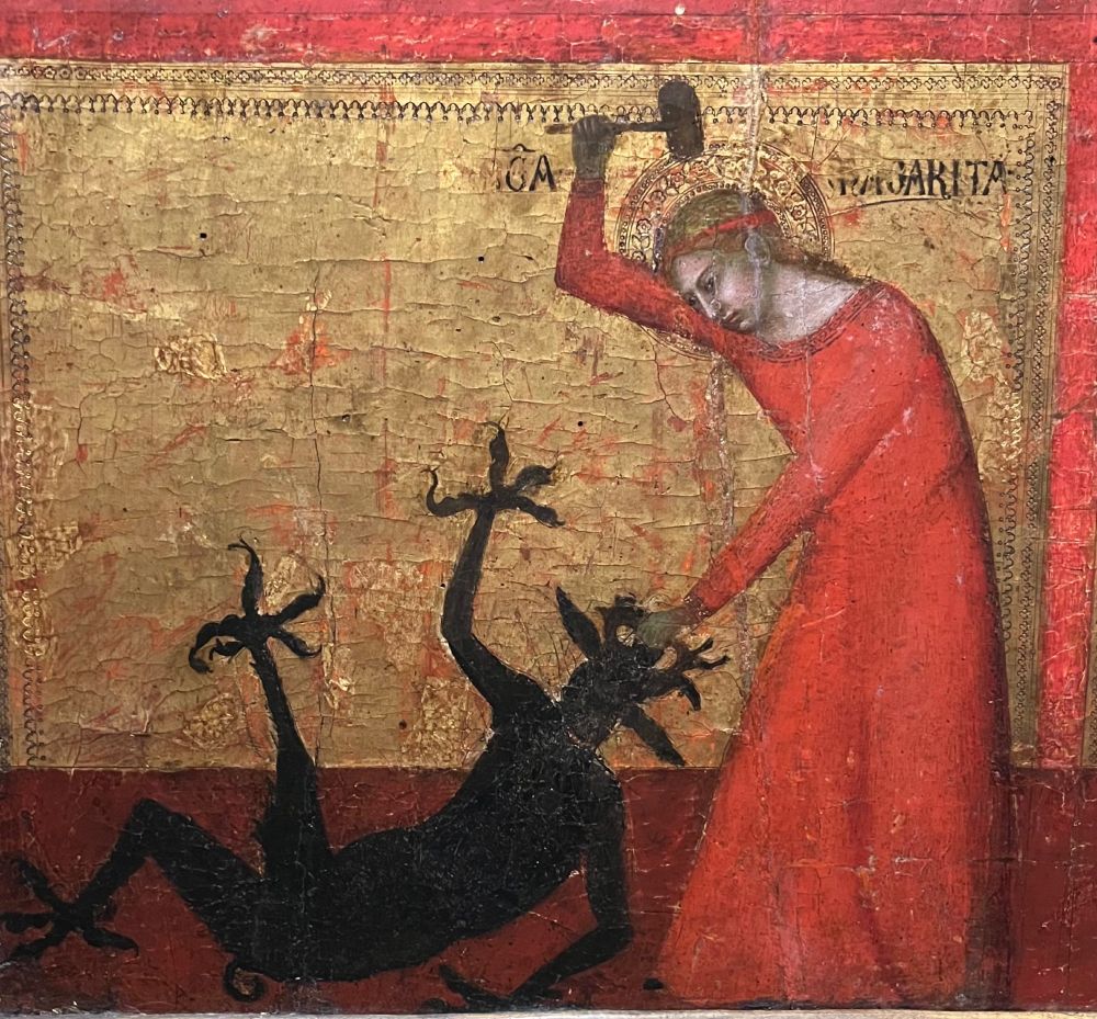 A woman in a red dress slaying a demon with a hammer