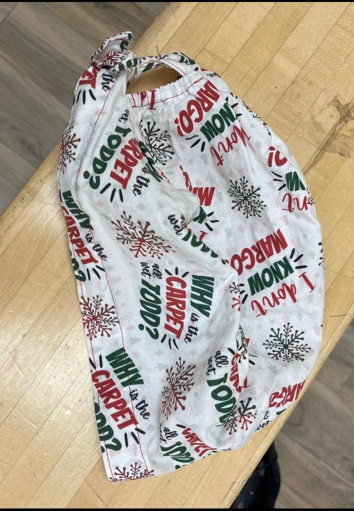 Surgical scrub hat with lines the movie Christmas Vacation on it. One line is “why is the carpet all wet Todd?” The other is “I don’t know Margo!”