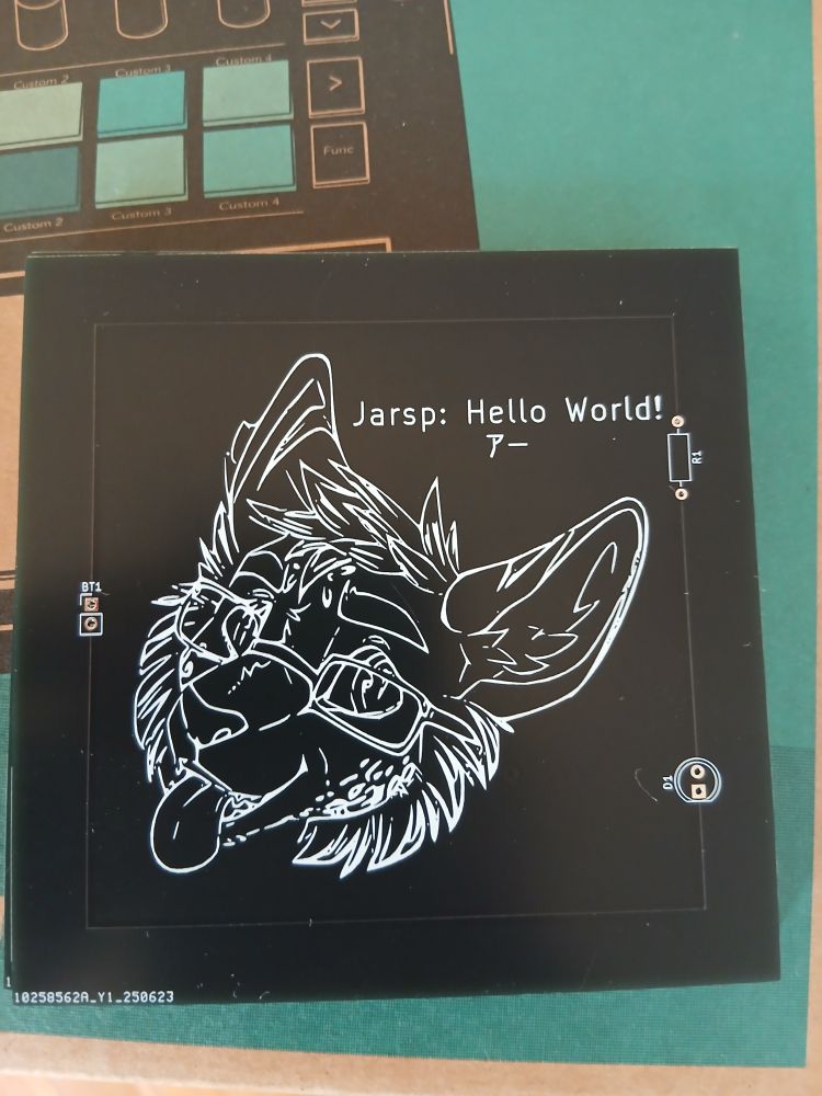 A PCB with a picture of a serval on it printed with silkscreen
