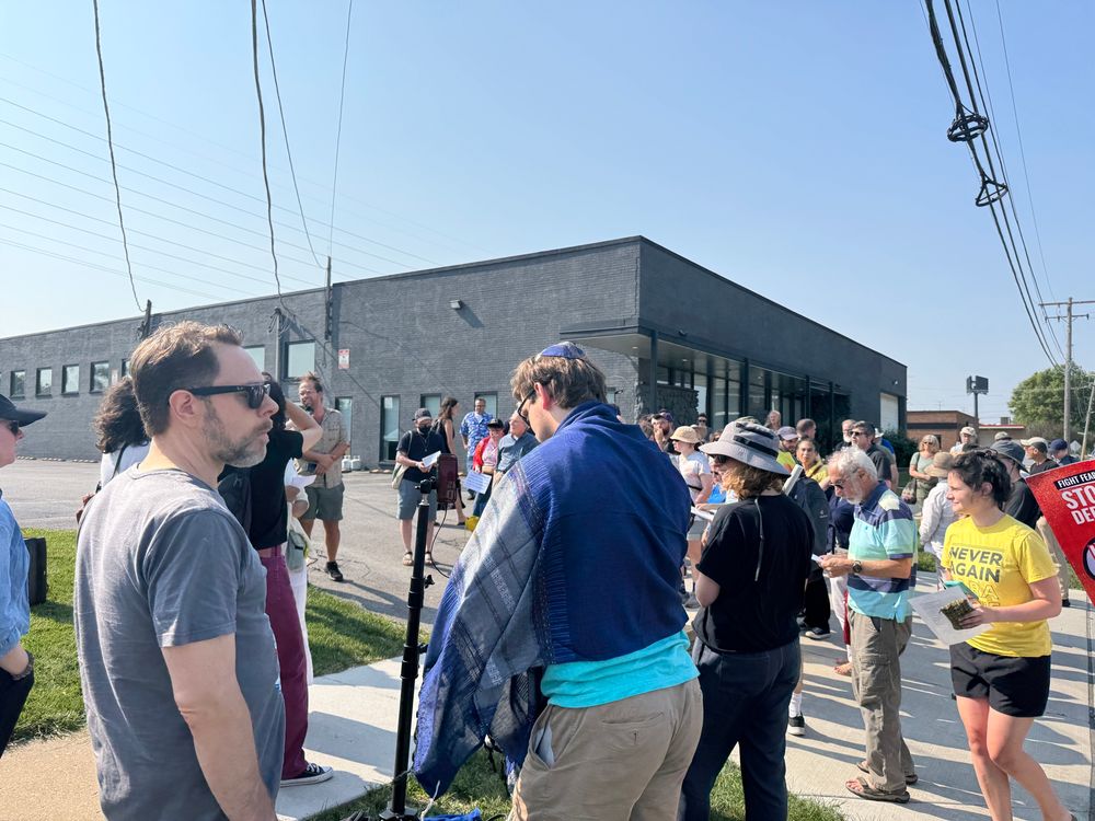 Dozens of people gathered in the parking entrance of the Broadview Detention Center Facility.