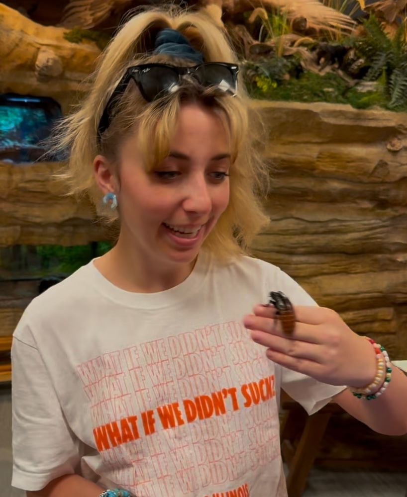 Me looking a little amused and also a little disgusted while holding a large bug at the Grove in Glenview